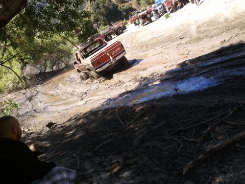 1978 Ford Bronco - Off-road vehicles tackle a challenging muddy terrain, with a 1978 Ford Bronco prominently featured.