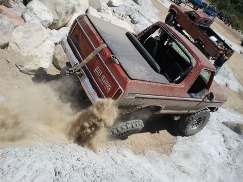 1978 Ford Bronco - 1978 Ford Bronco tackling rocky terrain, with another Bronco in the background.