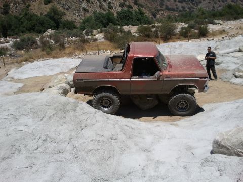 1978 Ford Bronco - This 1978 Ford Bronco is shown off-roading over rocks in a dry, mountainous area.