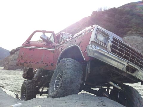 1978 Ford Bronco - This lifted 1978 Ford Bronco appears to be stuck in a sandy, off-road environment.