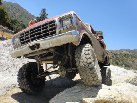 1978 Ford Bronco - This lifted 1978 Ford Bronco navigates a rocky trail with a driver giving a thumbs-up.