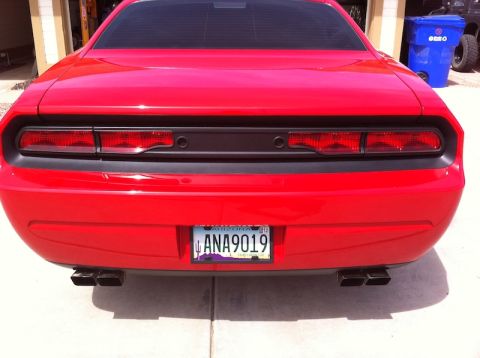 2010 Dodge Challenger - Rear view of a red 2010 Dodge Challenger, its distinctive taillights and dual exhaust.
