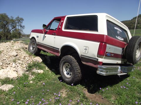 1989 Ford Bronco - This 1989 Ford Bronco is captured in a 3/4 front view while navigating an off-road trail.
