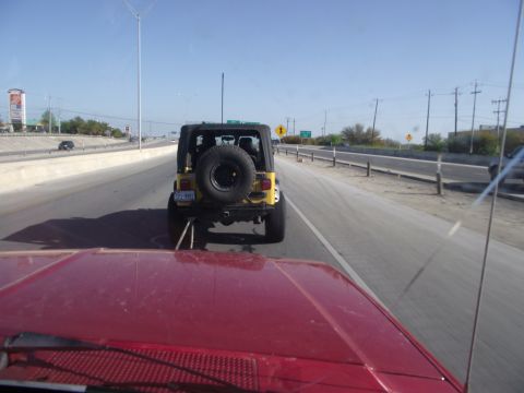 1989 Ford Bronco - Driving behind a yellow Jeep Wrangler on a sunny day on the highway.