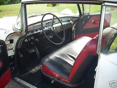 1991 Ford Crown Victoria - The interior of a classic car, likely a 1956 Buick Century, shows its two-tone seats and dashboard.