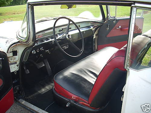 1956 Buick Century interior with black and red seats, dashboard, and steering wheel