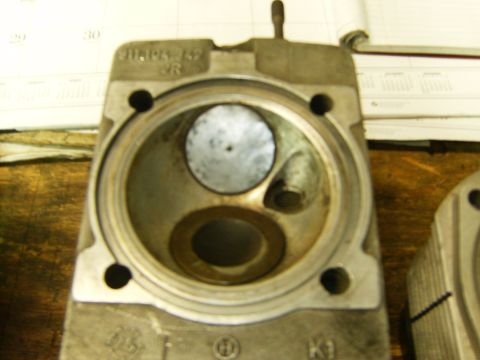 2000 Ford E350 - Engine cylinder head shown with part numbers visible, likely for a repair or rebuild.