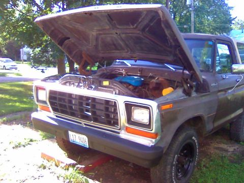 1979 Ford Bronco - Front view of a 1979 Ford Bronco with its hood raised, revealing the engine compartment.
