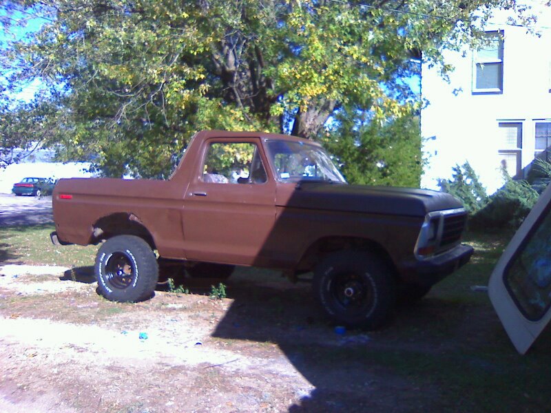 Brown 1978 Ford Bronco with black hood and aftermarket wheels, parked outdoors