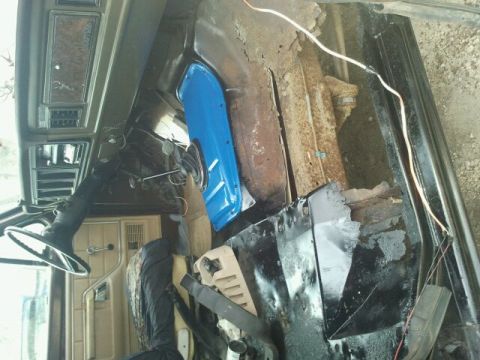 1979 Ford Bronco - Interior view of a 1979 Ford Bronco with significant rust damage visible on the floor pan.