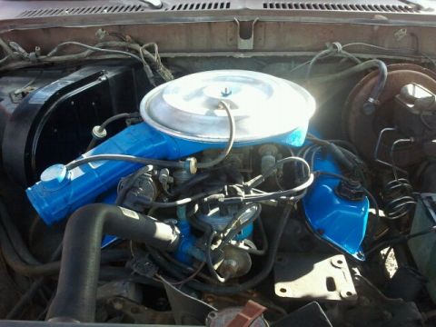 1979 Ford Bronco - Close-up view of the engine compartment, showing various hoses and mechanical components.