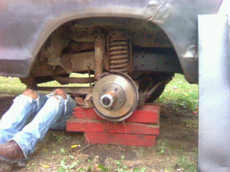 1979 Ford Bronco rear suspension with a person working on it