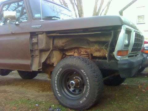 1979 Ford Bronco - The 1979 Ford Bronco is captured in a 3q-front view, its brown exterior.