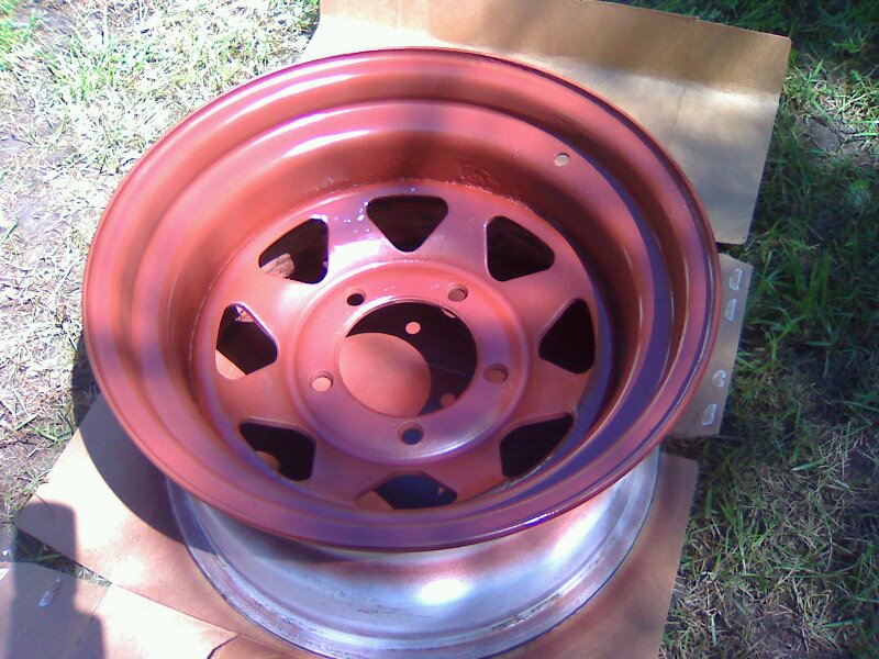 Red painted steel wheel with triangular cutouts