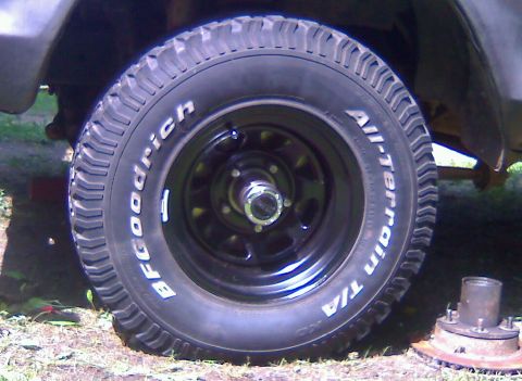 1979 Ford Bronco - Close-up of a BFGoodrich All-Terrain tire and wheel assembly, with a spare hub visible.