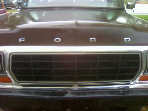 1979 Ford Bronco - Front view of a brown 1979 Ford truck, showing the grille and hood with the Ford emblem.