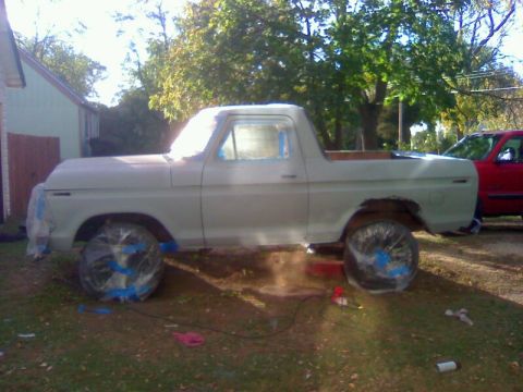 1979 Ford Bronco - This 1979 Ford Bronco is undergoing preparation for a new paint job, with its wheels carefully covered.