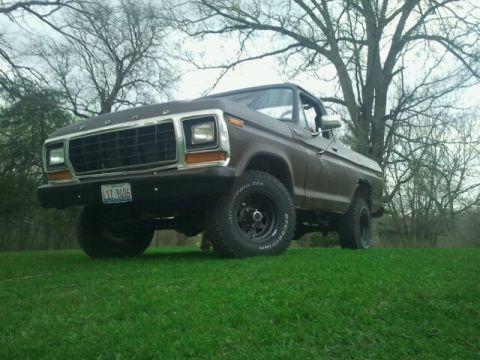 1979 Ford Bronco - This 1979 Ford Bronco features a distinctive grille and is captured from a three-quarter front angle on a grassy lawn.