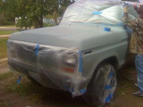 1979 Ford Bronco - A vehicle is being prepared for a paint job, with plastic sheeting covering most of its exterior.