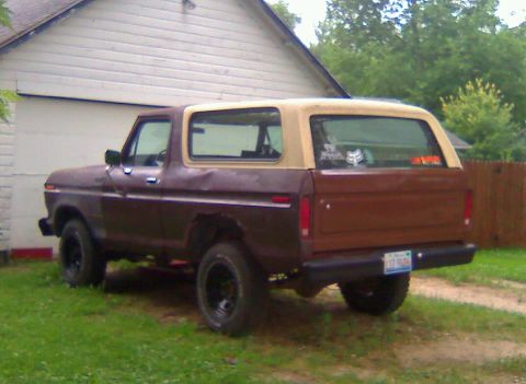 1979 Ford Bronco - Rear view of a brown 1978 Ford Bronco with a tan top, parked outdoors.