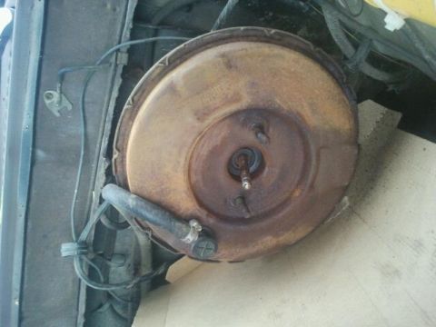 1979 Ford Bronco - A rusty brake booster assembly is visible, likely from an older vehicle's engine bay.