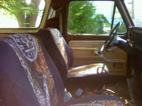 1979 Ford Bronco - Interior view of a 1979 Ford Bronco, camouflage seat covers and wood-grain trim.