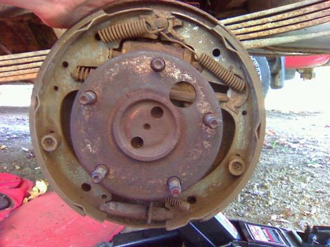 1979 Ford Bronco - Close-up of a rusty drum brake assembly, likely from an older vehicle.