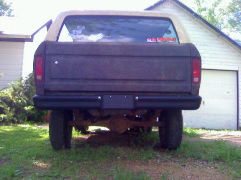 1979 Ford Bronco - This 1978 Ford Bronco shows its rear end, parked in front of a garage.