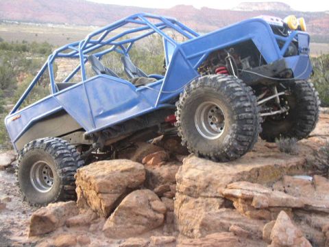 1979 Ford Bronco - This custom buggy is navigating a rocky trail in a desert landscape.