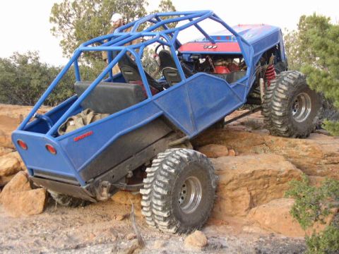 1979 Ford Bronco - A custom-built off-road buggy navigates a challenging rocky landscape.