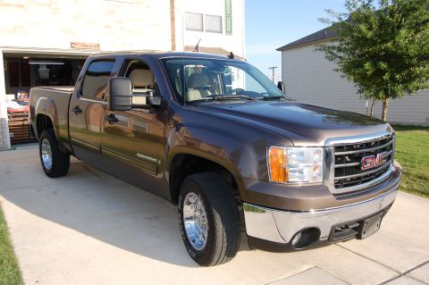 2007 GMC Sierra 1500 - Front 3/4 view of a brown 2007 GMC Sierra 1500 pickup truck.