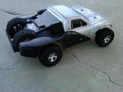 1986 Ford Bronco - This remote control truck has a silver body and black fenders, with large off-road tires.