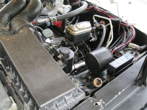 1978 Ford Bronco - Close-up view of an engine bay, showing various components and wiring harnesses.