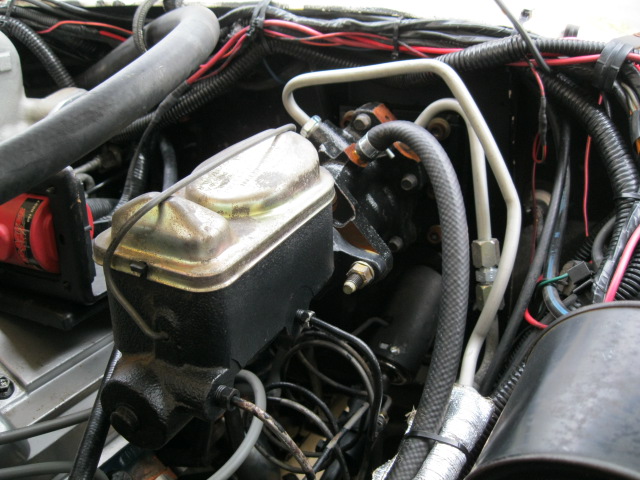 Engine bay detail showing brake master cylinder and associated lines