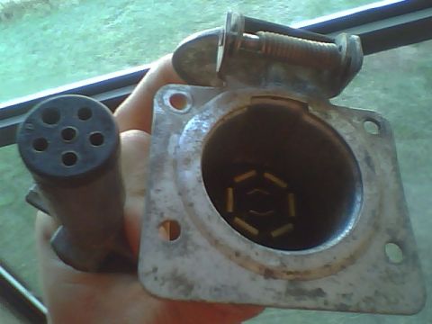 1987 Ford F-250 - Close-up of a trailer hitch connector and its corresponding plug.
