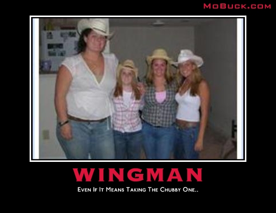 Four women in cowboy hats and jeans stand indoors