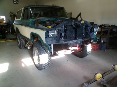 1979 Ford Bronco - This 1979 Ford Bronco is in a garage with its hood open, showing the engine bay.