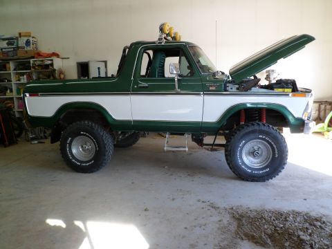 1979 Ford Bronco - This 1979 Ford Bronco is parked in a garage with its hood up, revealing the engine bay.