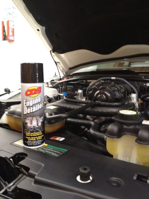 2007 Ford Mustang - A can of engine detailer sits in the engine bay of a vehicle with the hood open.