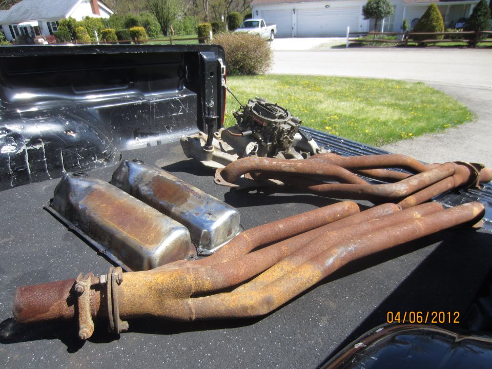 Engine manifold and valve covers in truck bed