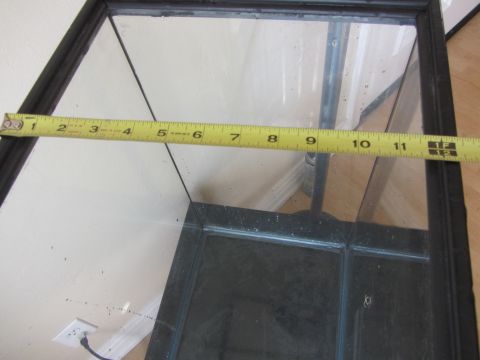 1968 Ford Mustang - A tape measure is placed across a glass tank, indicating its dimensions.
