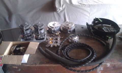 1978 Ford Bronco - Collection of carburetors and fuel lines, possibly for an engine rebuild or upgrade.