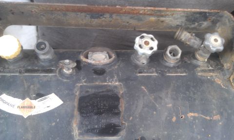1978 Ford Bronco - Close-up of propane tank valves and connectors, showing various fittings and a 'Propane Flammable' sticker.