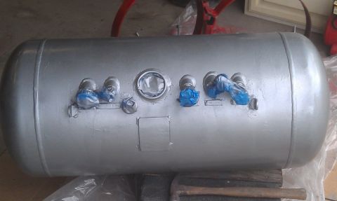 1978 Ford Bronco - Propane tank with fittings, some taped off, resting on a surface.