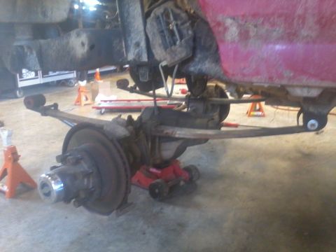 1995 Ford F-150 - Close-up of a vehicle's undercarriage, showing suspension parts and frame structure.