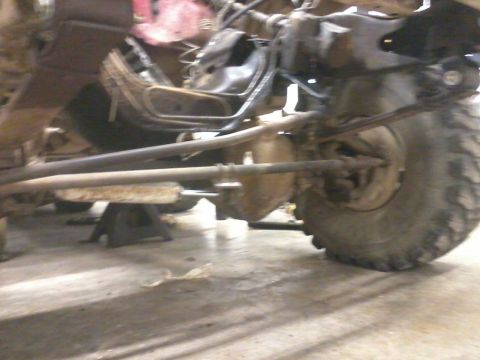 1995 Ford F-150 - Front suspension and tire of a 1995 Ford F-150, supported by jack stands.