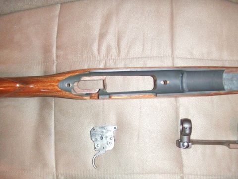 1996 Ford Bronco - Disassembled rifle components laid out on a textured surface.