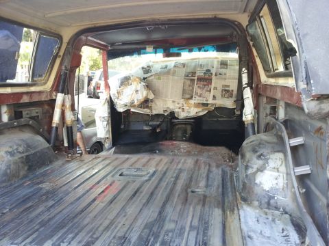 1978 Ford Bronco - Interior of a 1978 Ford Bronco being prepped for restoration, dashboard covered with newspaper.