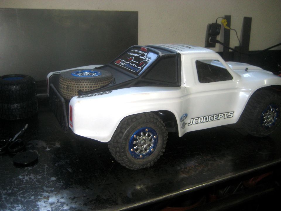White RC truck with JConcepts branding and spare tire in bed