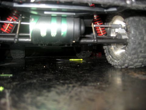 1996 Ford Bronco - The chassis of an RC car is visible, with suspension components and a motor. A screwdriver is on the floor nearby.